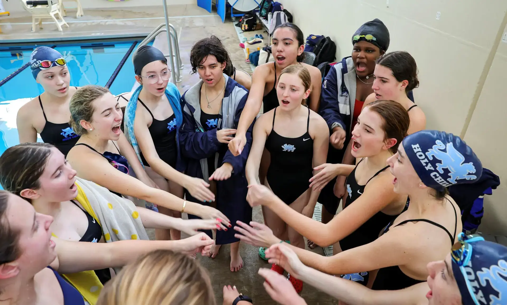 Swim team celebrating together by the pool