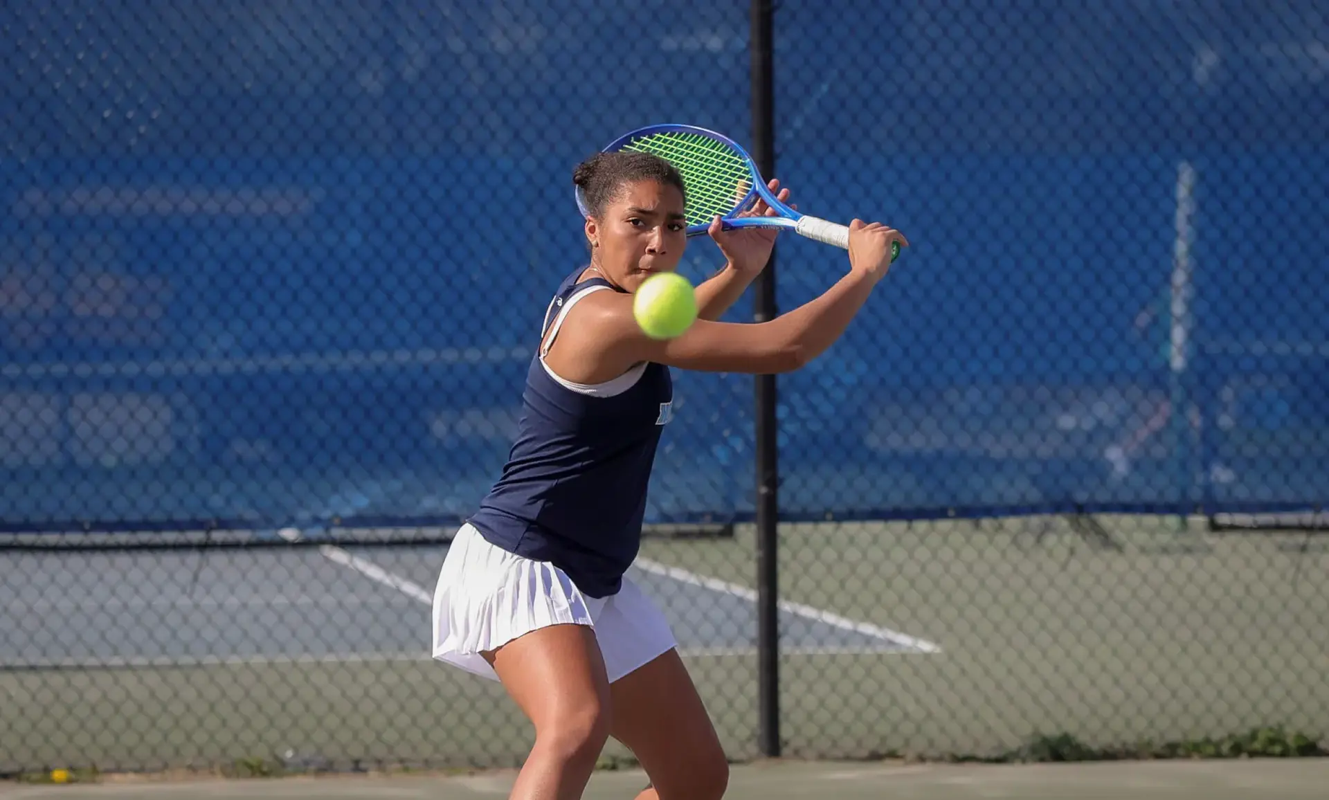 Student playing tennis