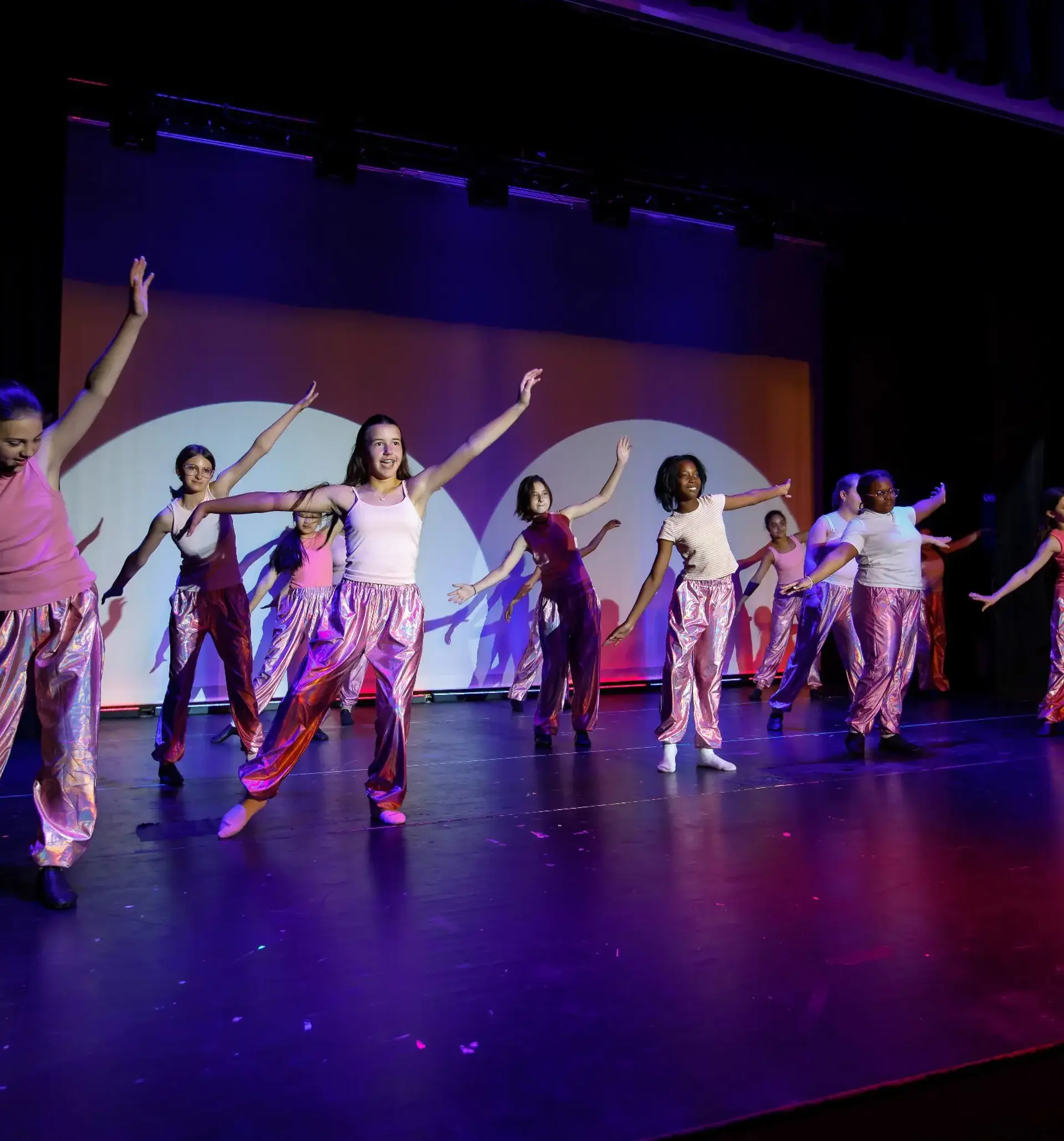 Middle School students performing on stage.