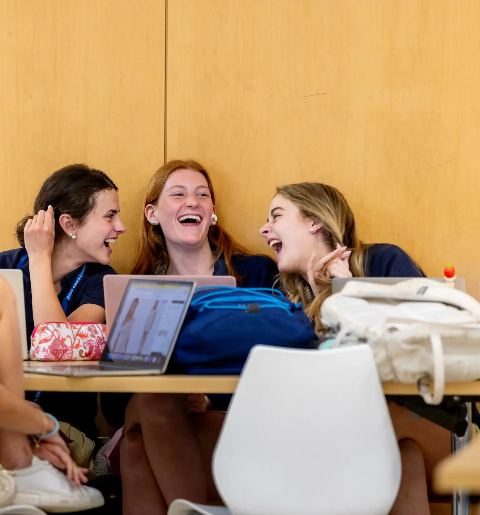 Upper School friends at Holy Child laughing in the Dining Hall
