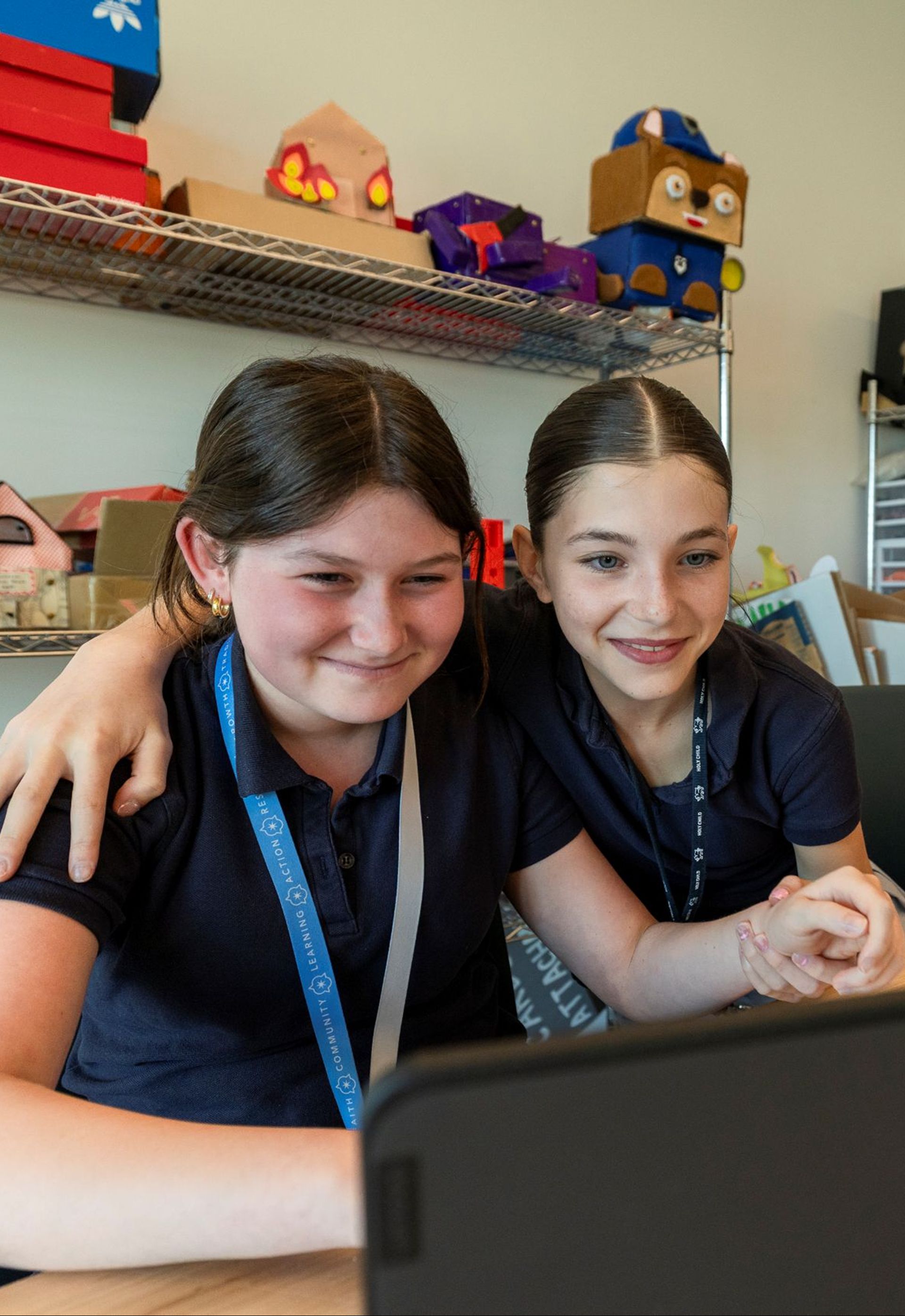 Holy Child students working together at a computer.
