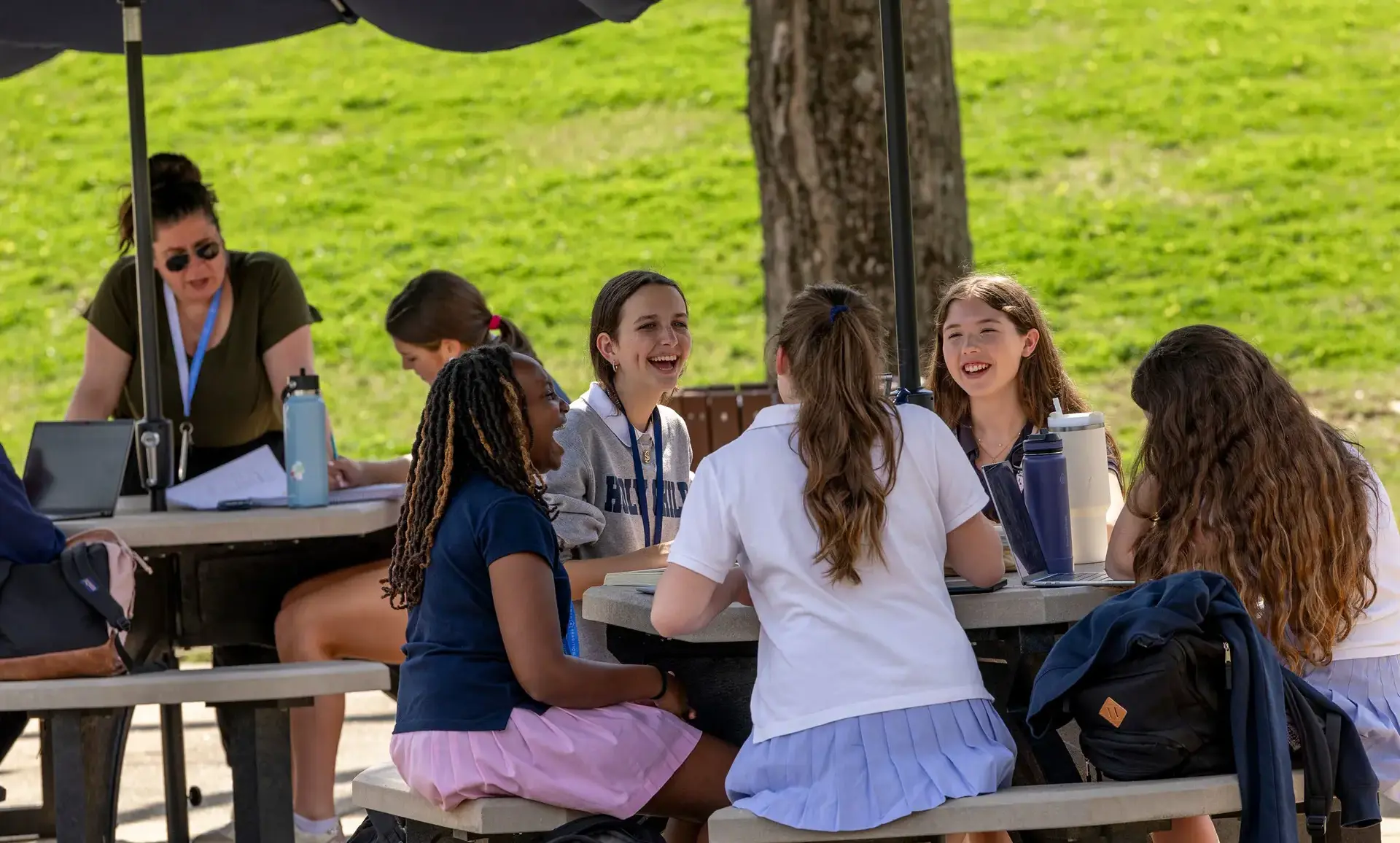 Students sitting outdoors laughing