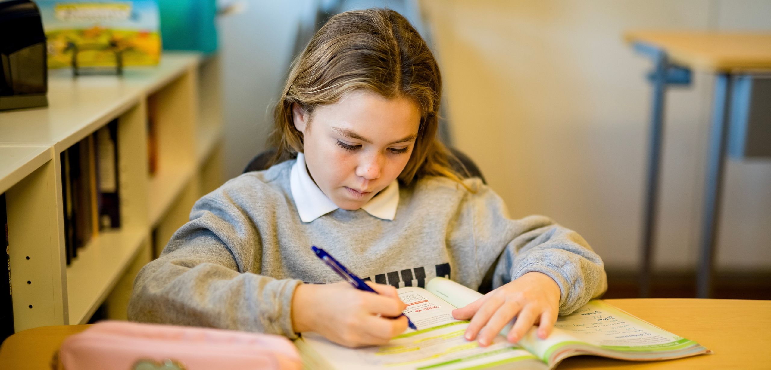 Student writing on a notebook