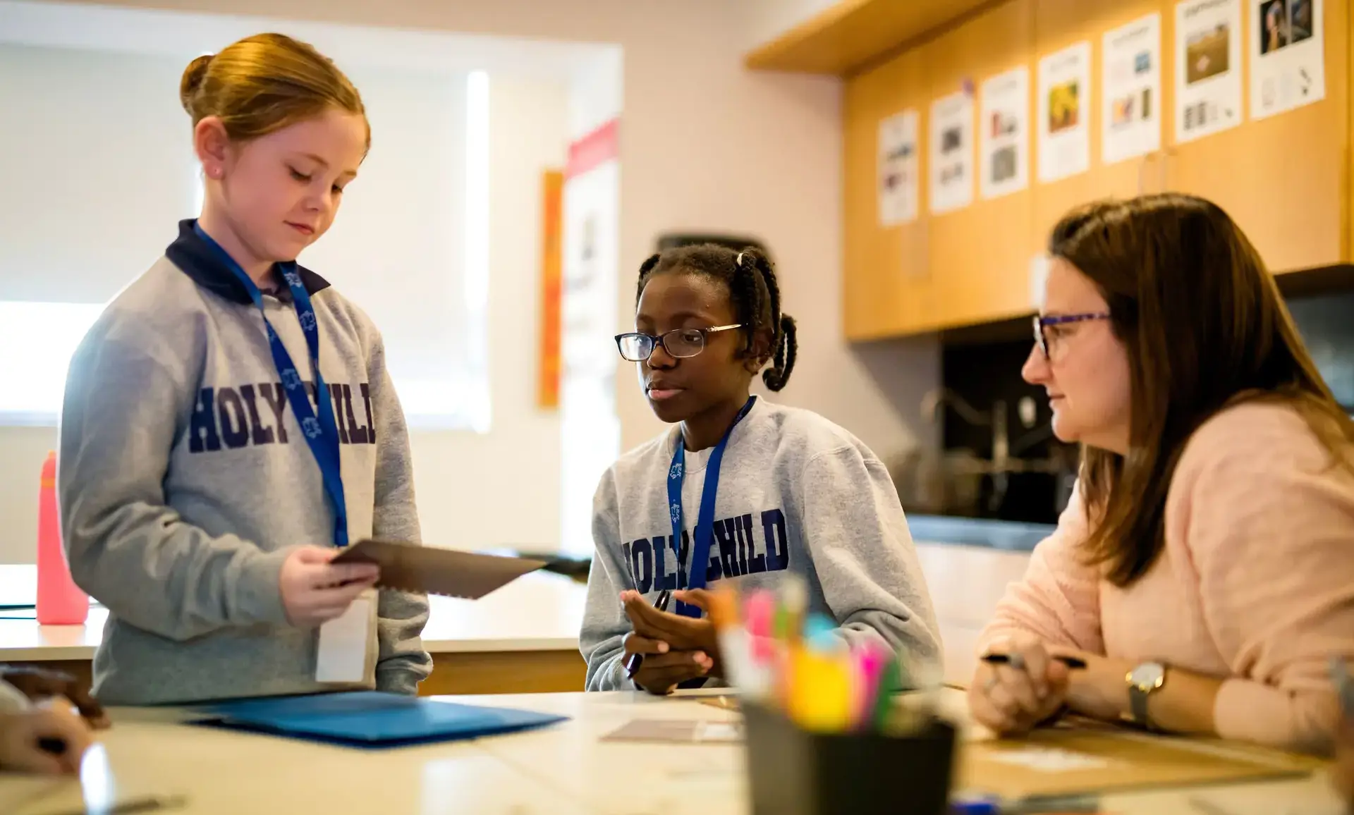 Teacher helping students during a classroom activity
