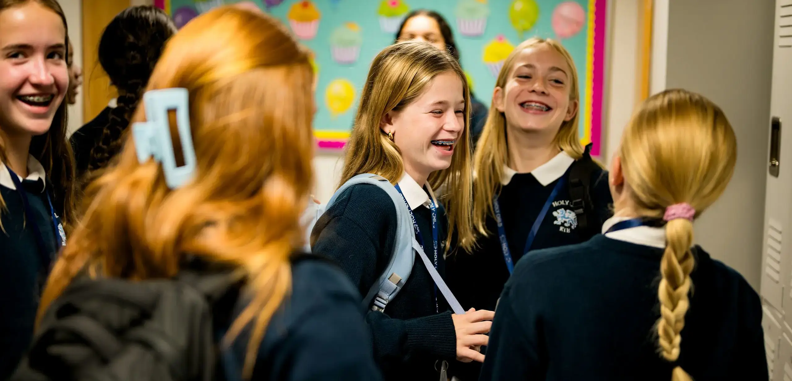 Students laughing together in the school hall