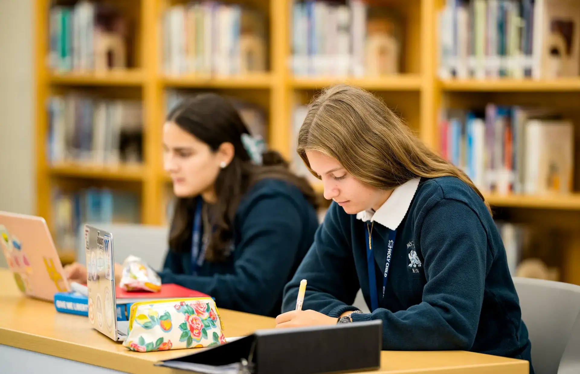 Student writing on a notebook