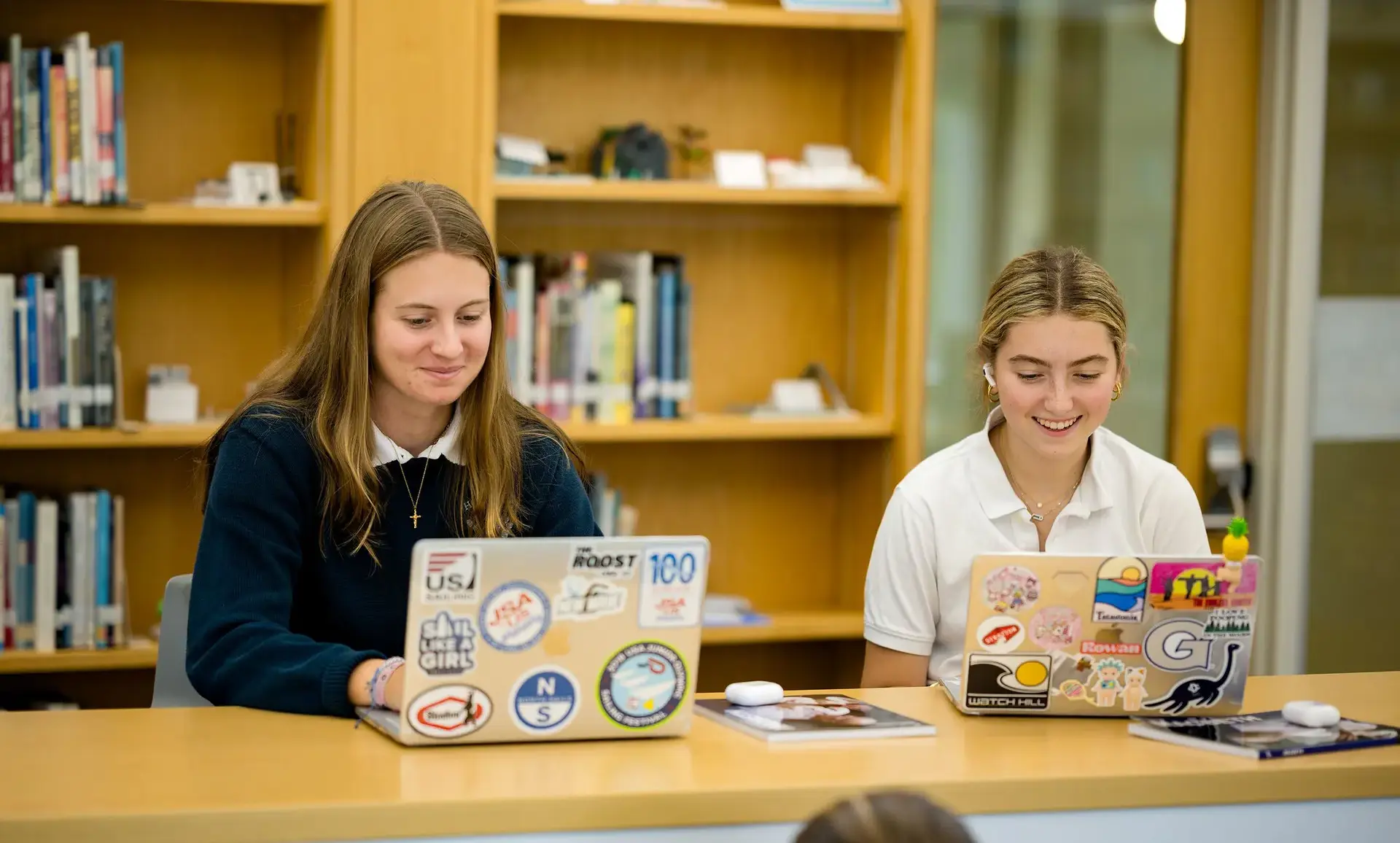 Students typing on a laptop
